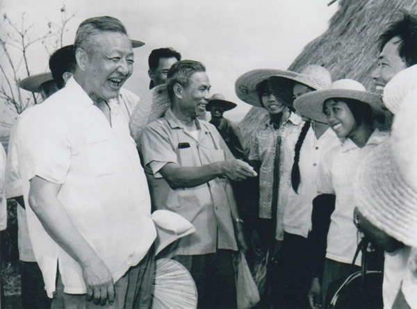 1980年8月底至9月初，習(xí)仲勛（左一）在廣東湛江農(nóng)村視察時(shí)與青年親切交談。